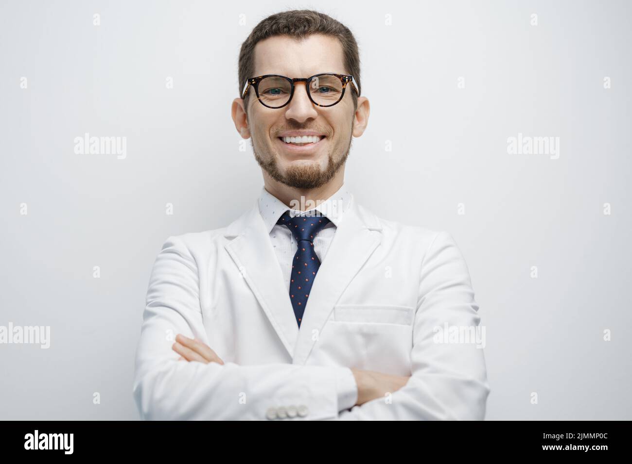 Portrait of male doctor smiling isolated on white background Stock Photo