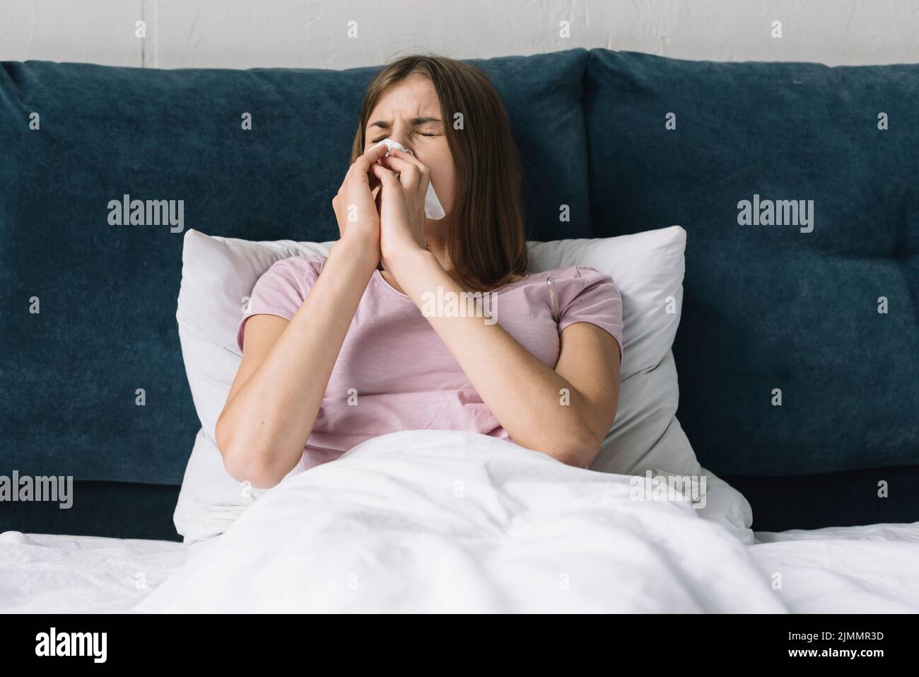 Pretty woman lying bed suffering from cold Stock Photo Alamy