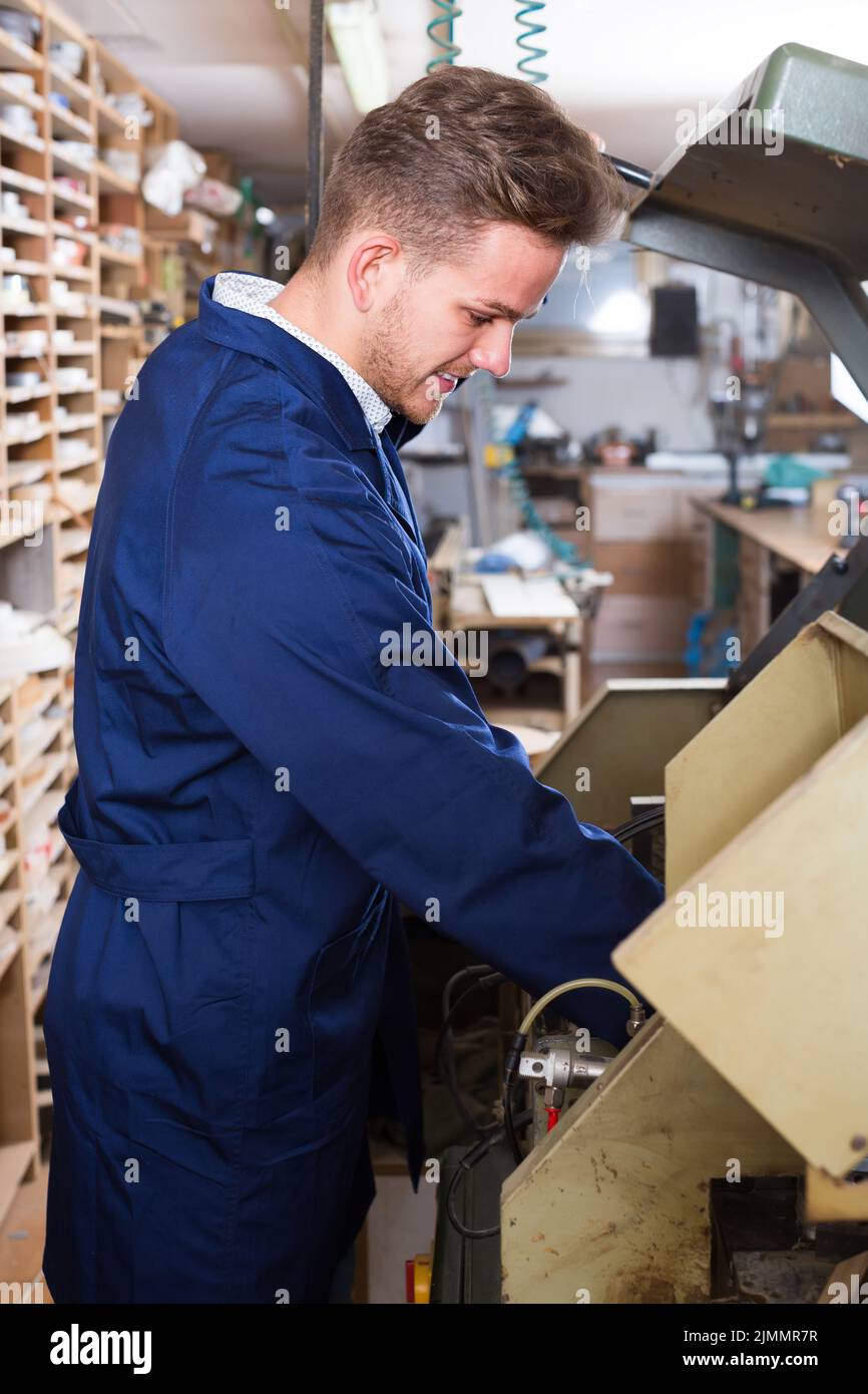 Young woodworker working with trimming machine Stock Photo Alamy