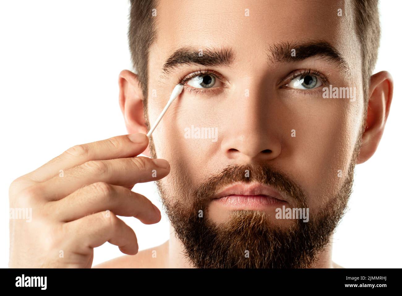 Man cleaning his eye with a cotton swab Stock Photo Alamy