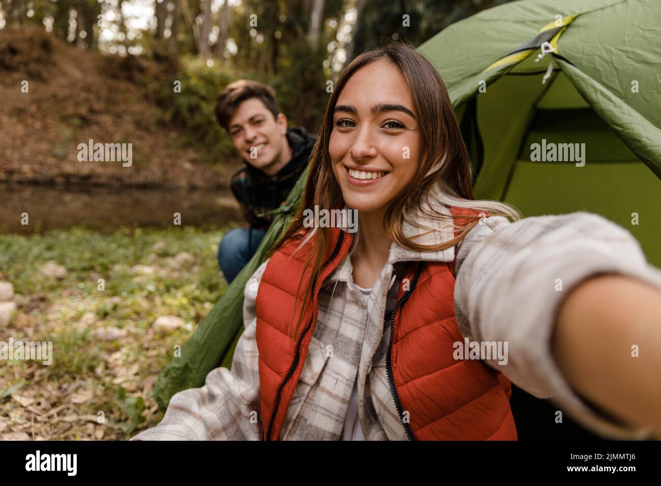 Happy couple forest taking selfie Stock Photo