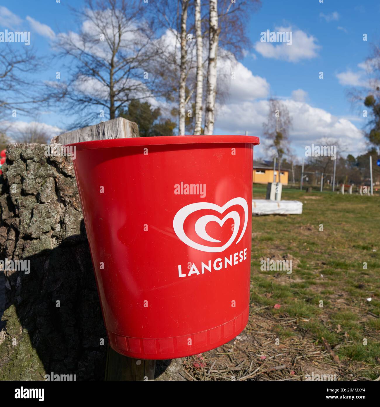 Red trash can of ice cream manufacturer Langnese on a campsite in Germany Stock Photo
