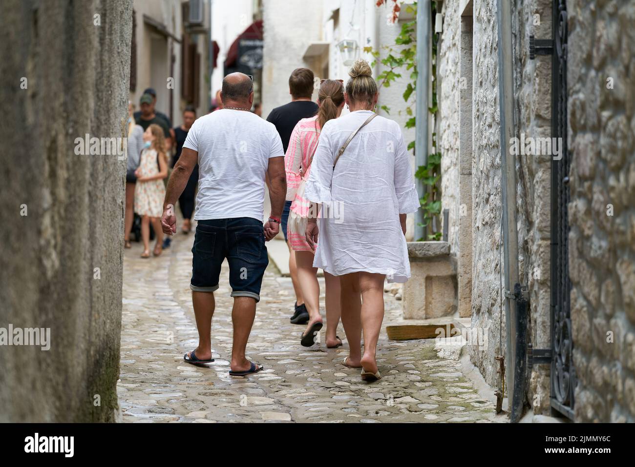 Tourists walking through the historic old town of Krk in Croatia Stock Photo