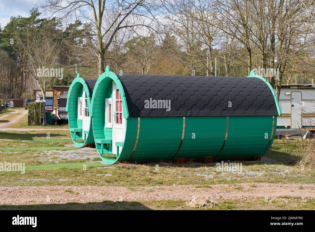 Wooden sleeping barrel to spend the night on a campsite in Germany Stock Photo