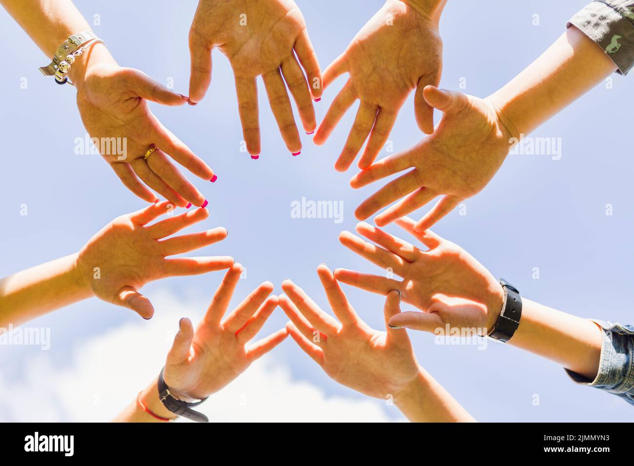 Crop hands stacked together circle Stock Photo