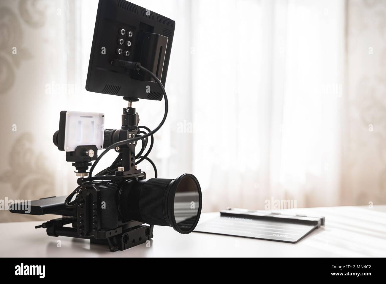 Modern black mirrorless camera rig and clapperboard Stock Photo Alamy
