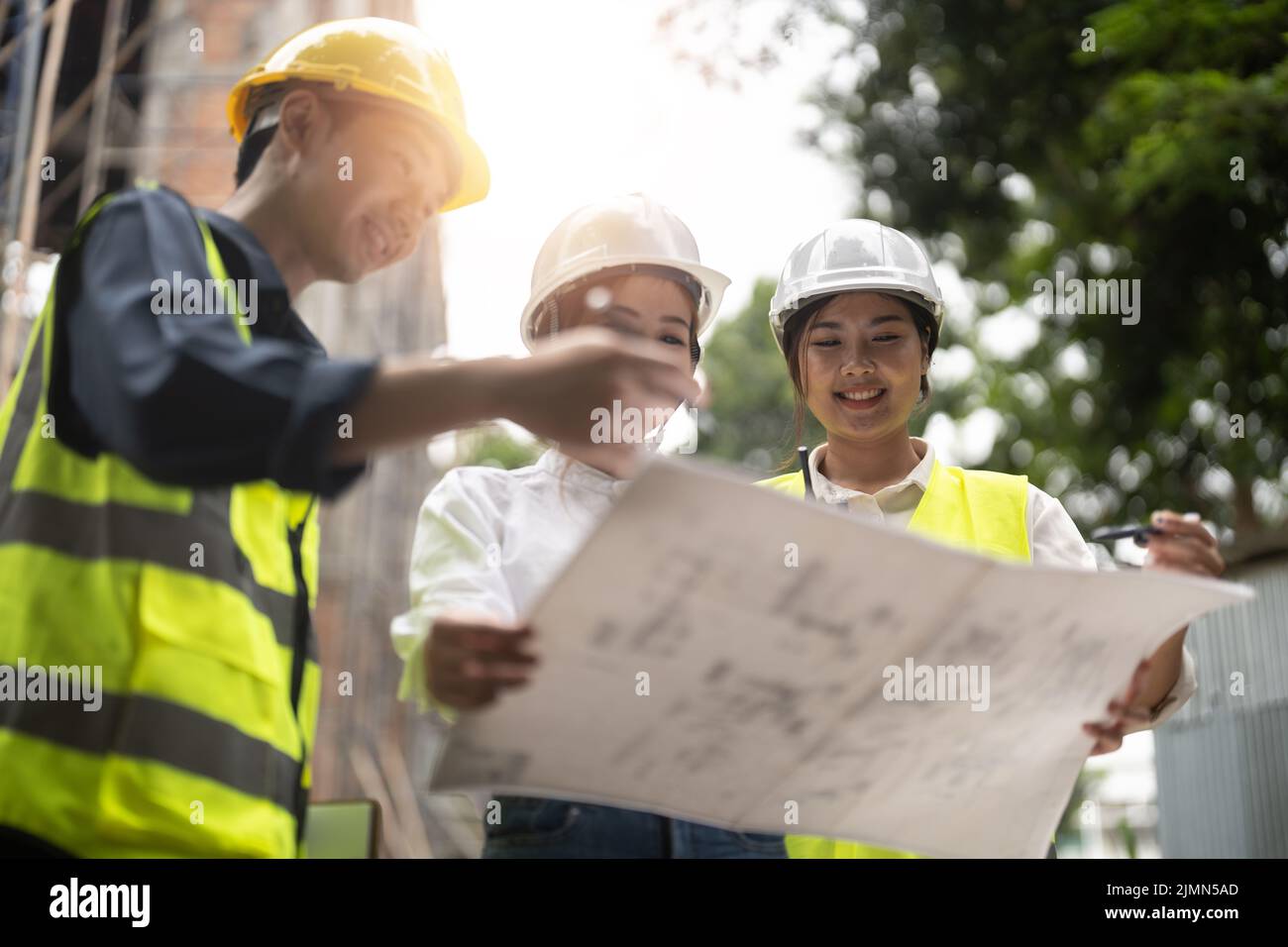 Construction engineers discussion with architects at construction or building site Stock Photo