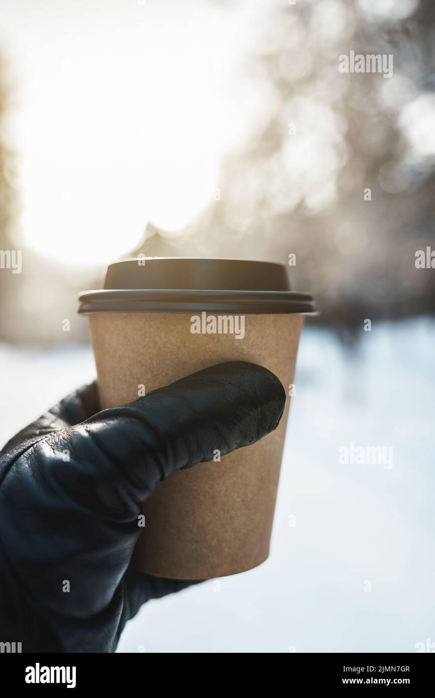 Hand with a paper cup of hot coffee during cold winter day Stock Photo ...