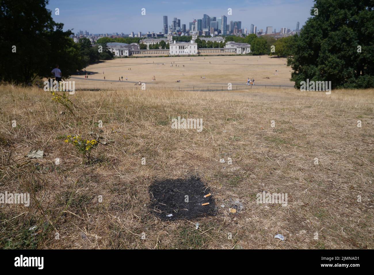 A scorched mark left behind by a disposable barbeque in Greenwich Park, London. Picture date: Sunday August 7, 2022. Stock Photo