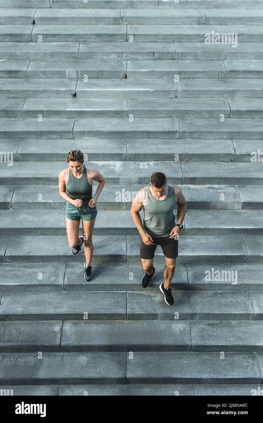Sportive couple during workout stair running outdoors Stock Photo - Alamy
