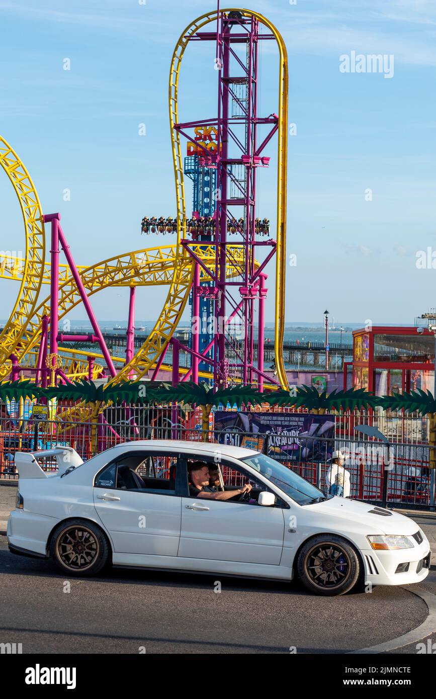 Car cruise event in Southend on Sea, Essex, UK, in the evening after a hot summer day. Car passing Adventure Island theme park Stock Photo