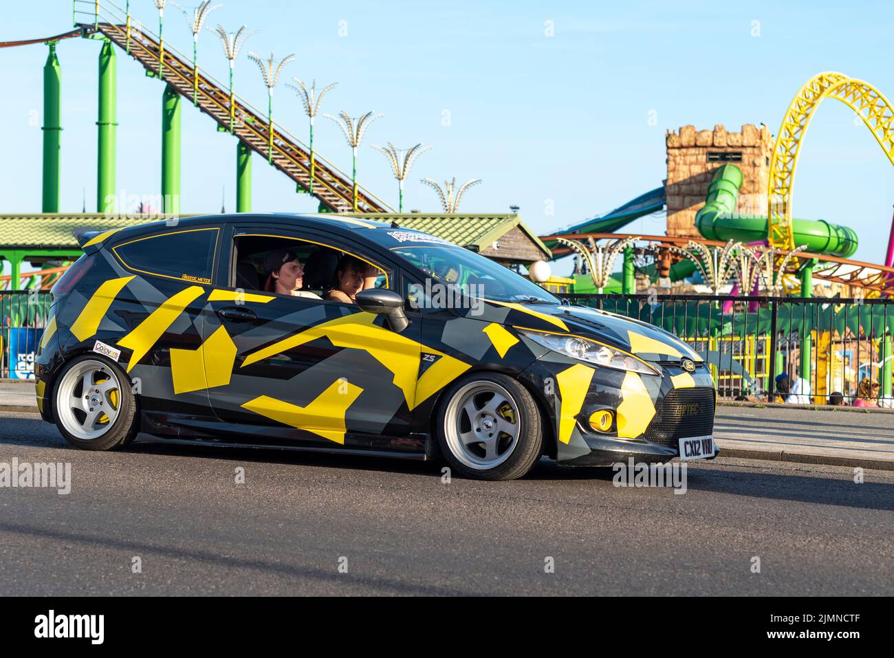 Car cruise event in Southend on Sea, Essex, UK, in the evening after a hot summer day. Ford Fiesta Zetec S with custom splinter camo wrap colours Stock Photo