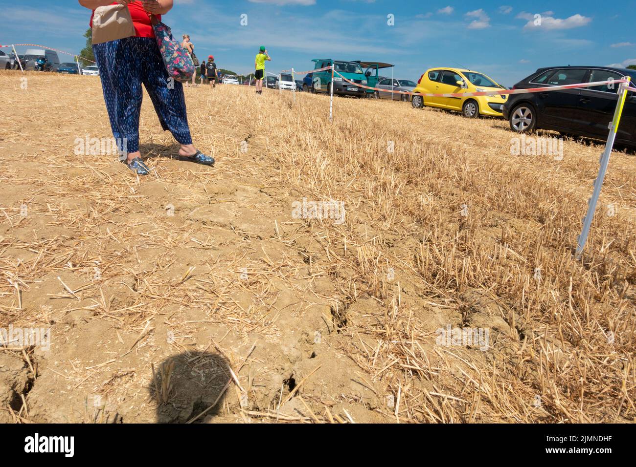 Woodchurch, Kent, UK. 7th Aug, 2022. UK Weather: Harvested fields used for parking in Woodchurch hosting the Weald of Kent Steam Rally show deep cracks in the fields through lack of rain water as the drought continues in the South East. Photo Credit: Paul Lawrenson/Alamy Live News Stock Photo