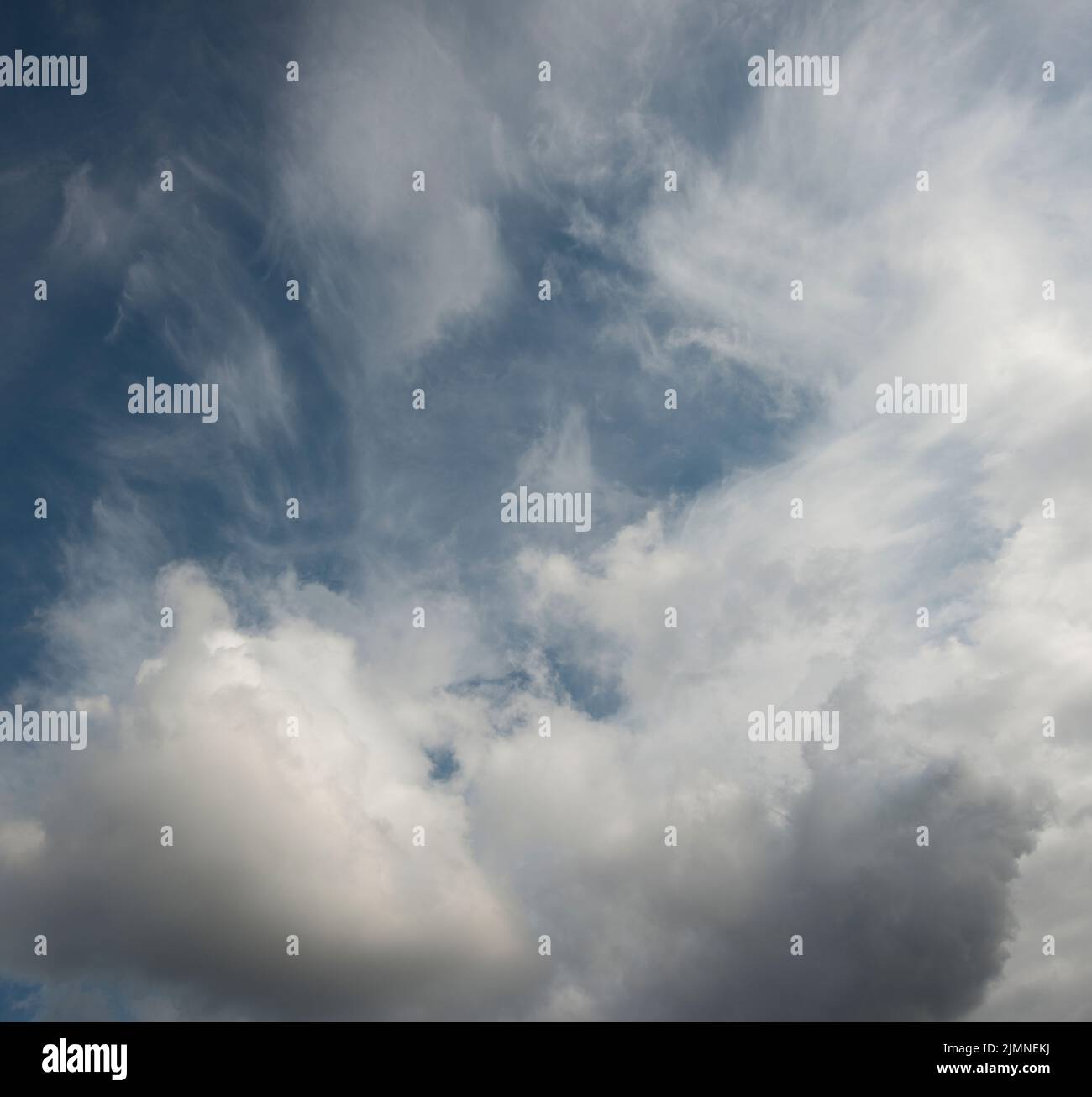 soft white puffy clouds building over a blue sky Stock Photo - Alamy