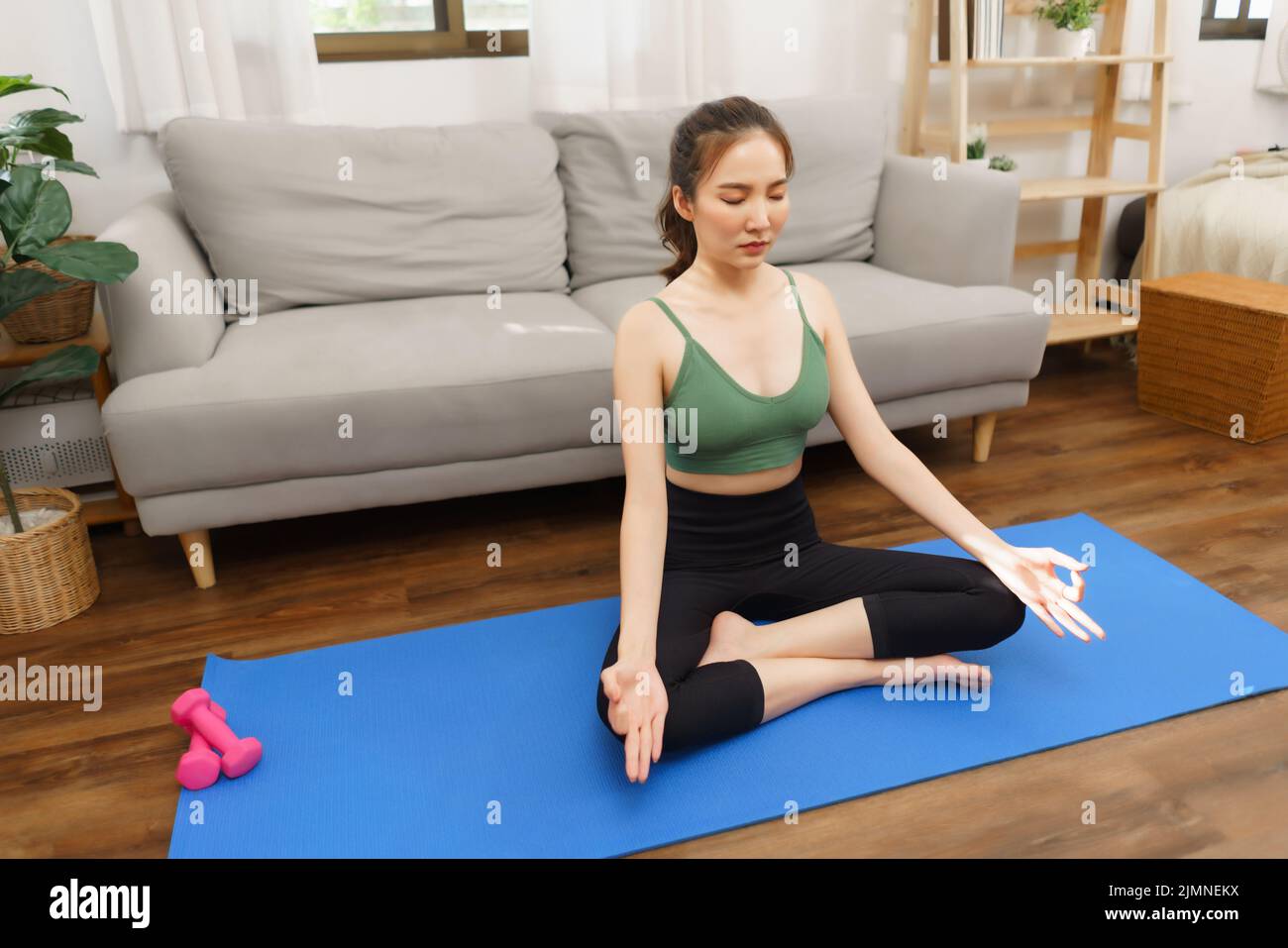 Yoga and wellness concept, Young Asian woman doing yoga with meditation