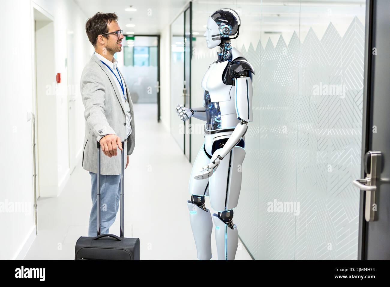 Humanoid robot assists company visitors Stock Photo