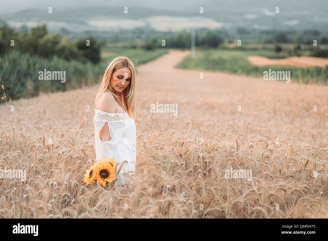 Girl standing in sunflower field hi-res stock photography and images ...