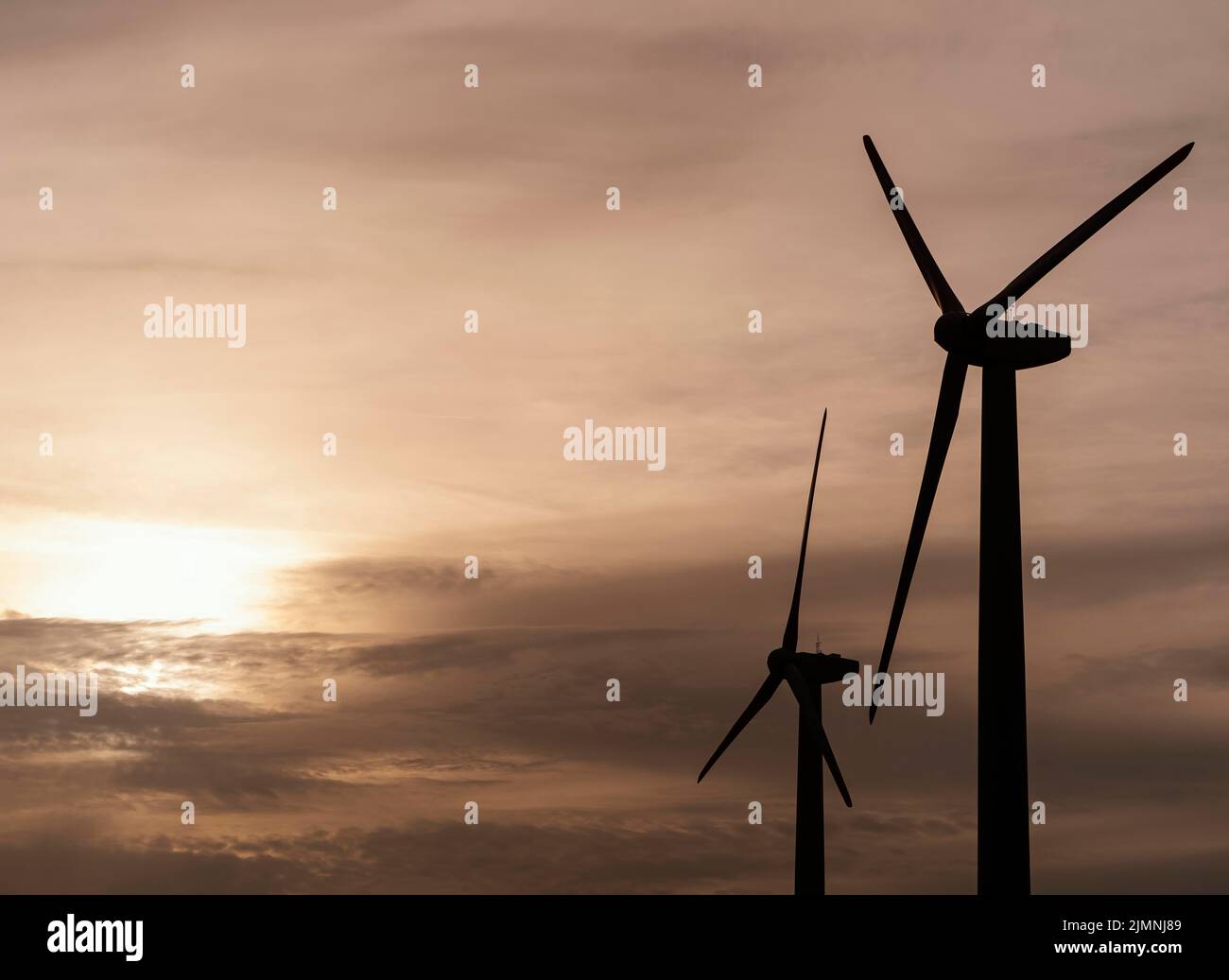 Side view wind turbine silhouette generating electricity Stock Photo