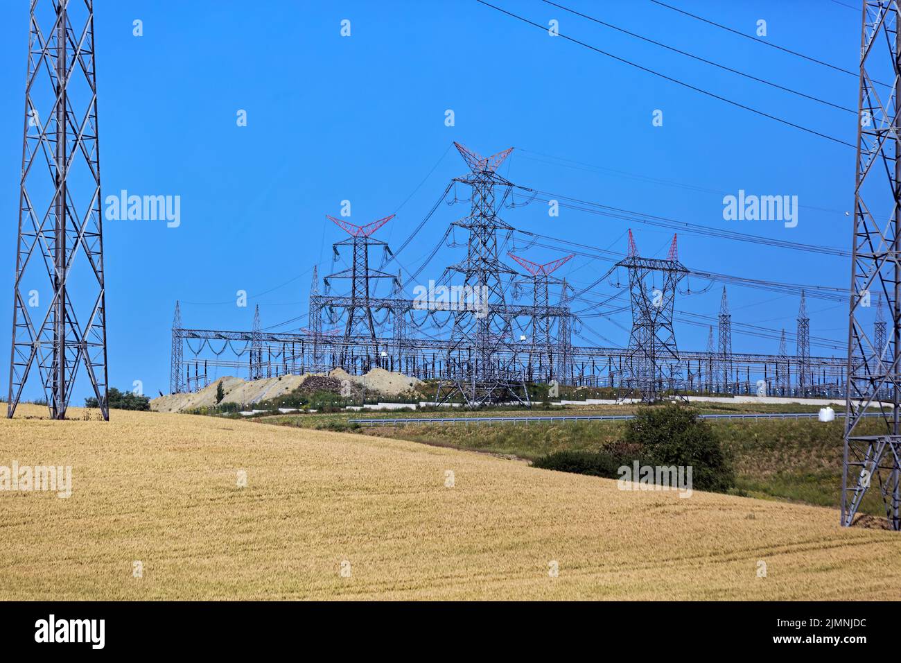 Power lines and pylon electricity pols along with crop fields in the