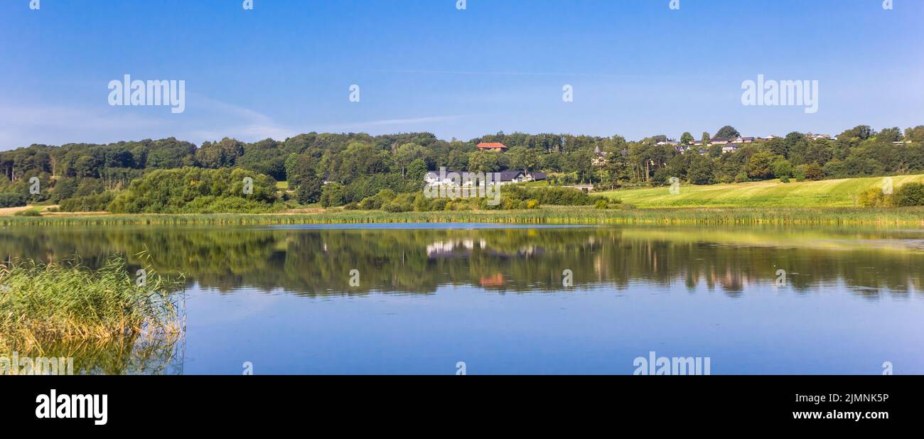 Panorama of the tranquil water of the blue lake near Hobro, Denmark Stock Photo