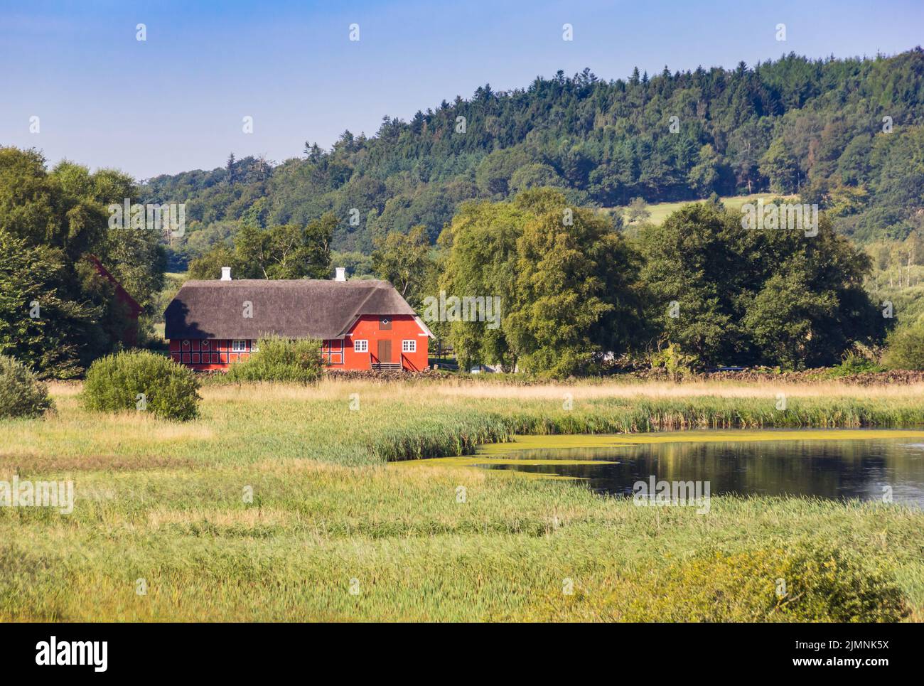 Typical danish farmstead at the lake near Hobro, Denmark Stock Photo