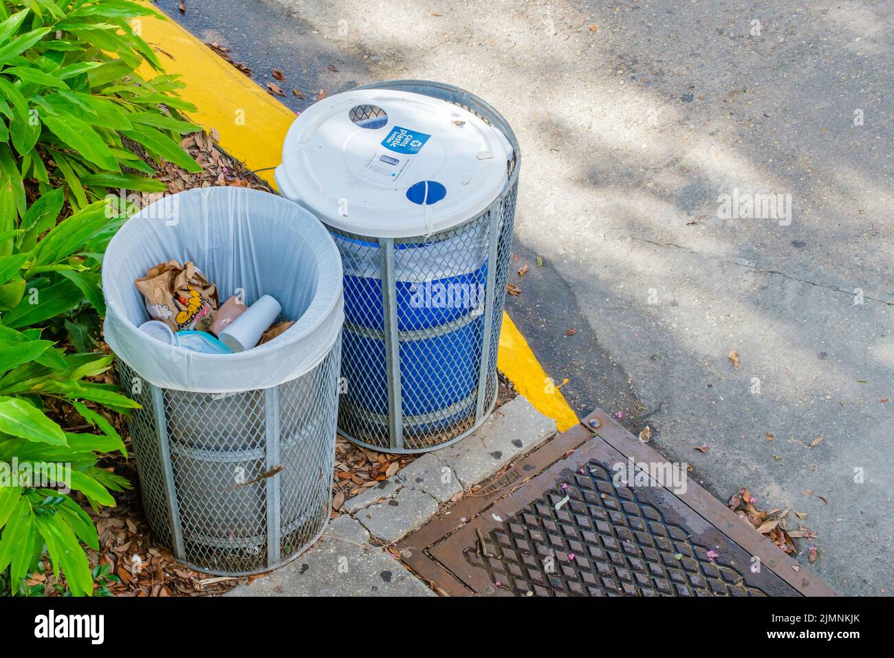 NEW ORLEANS, LA, USA - AUGUST 5, 2022: Trash can next to recycling can on Tulane University campus Stock Photo