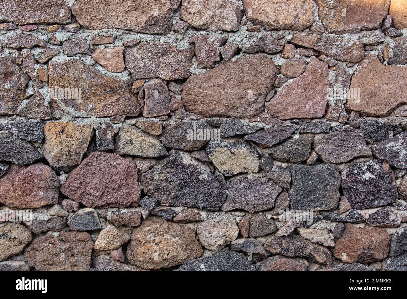 Masonry granite stone wall background. Build with old style. Stock Photo