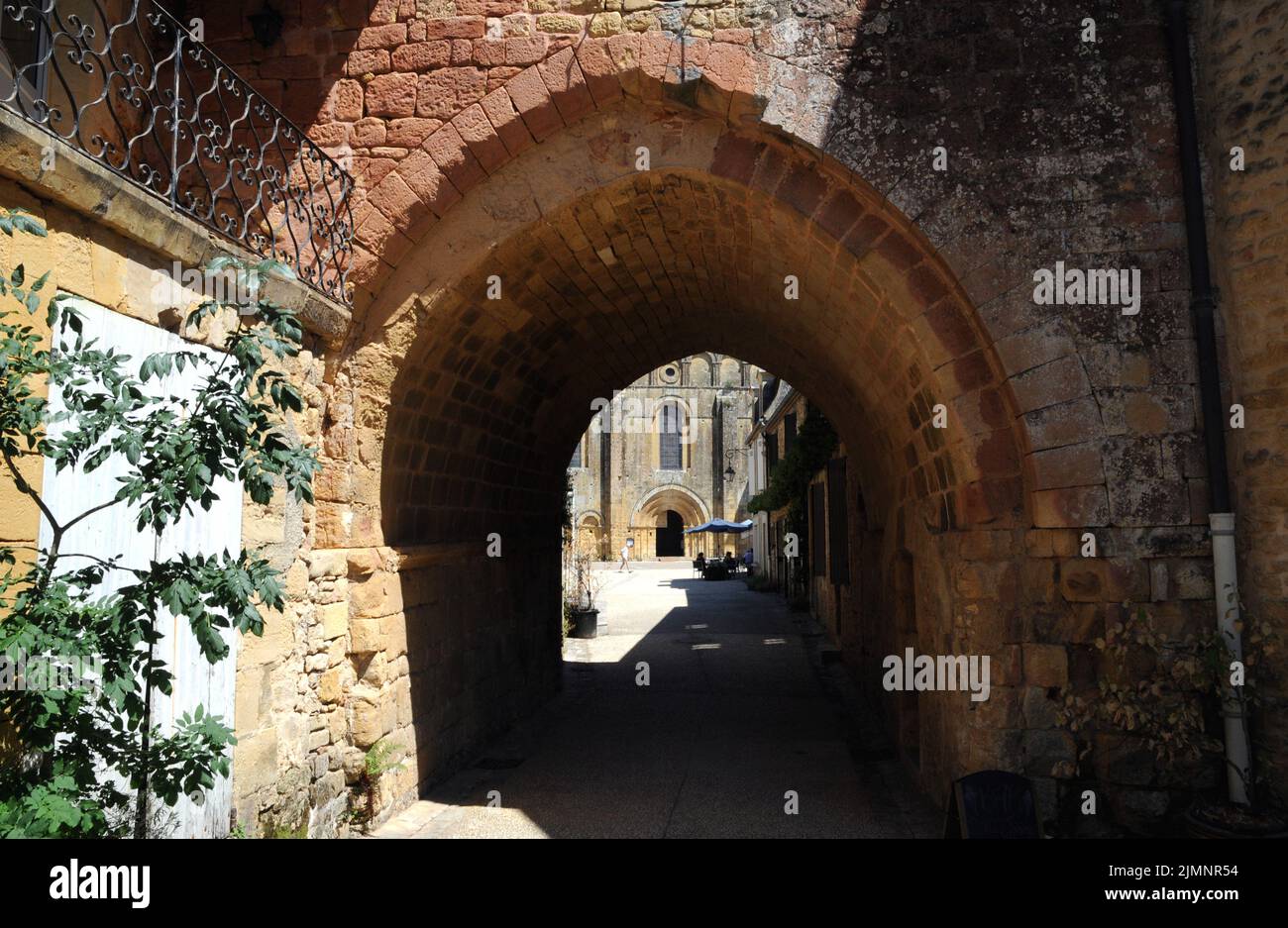 An archway in the village of Cadouin, Perigord Noir, leads from a narrow street through to the large market square and the beautiful abbey church. Stock Photo