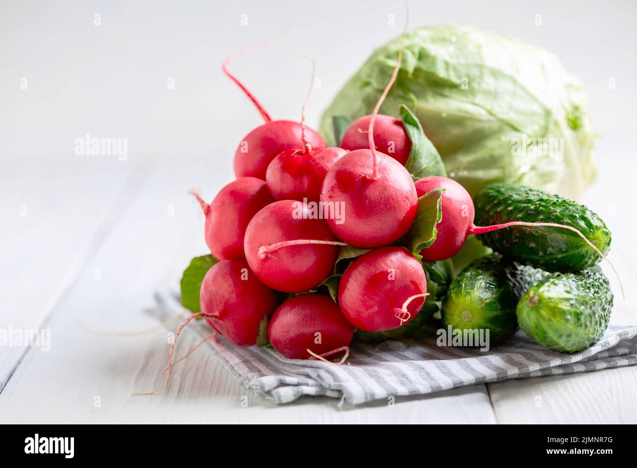 Radishes, cucumbers and cabbage in close-up. Stock Photo