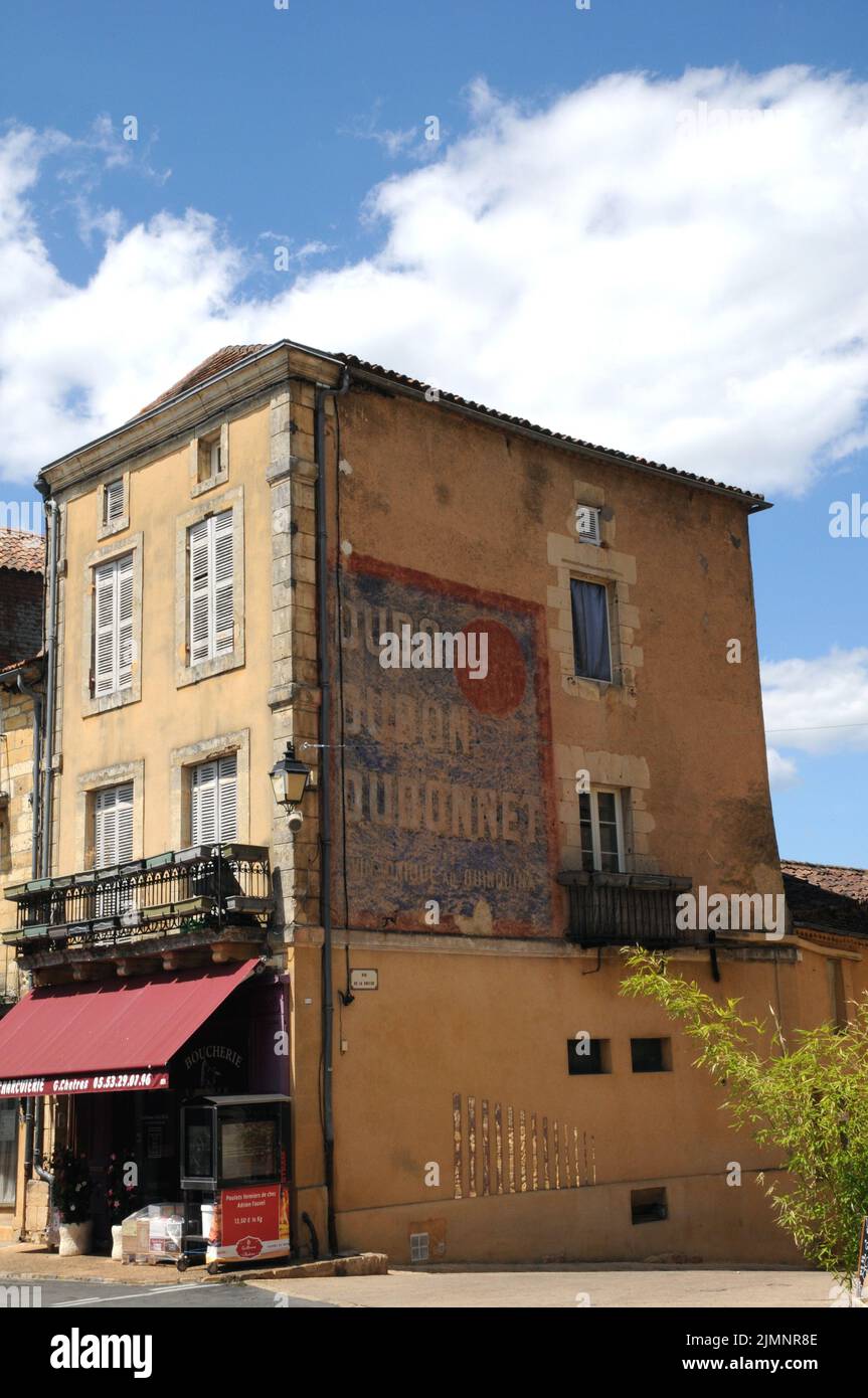 An advertisement for the aperitif Dubonnet on the side of a shop in the town of Belvès in the Dordogne region of south west France. Stock Photo