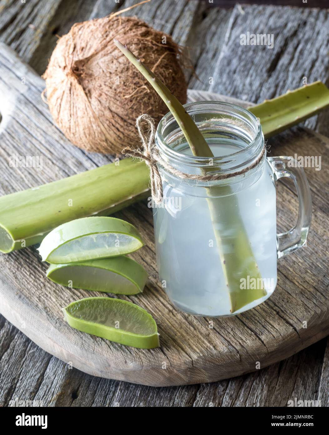 Coconut water with aloe vera pieces in a jar, ready for drinking Stock