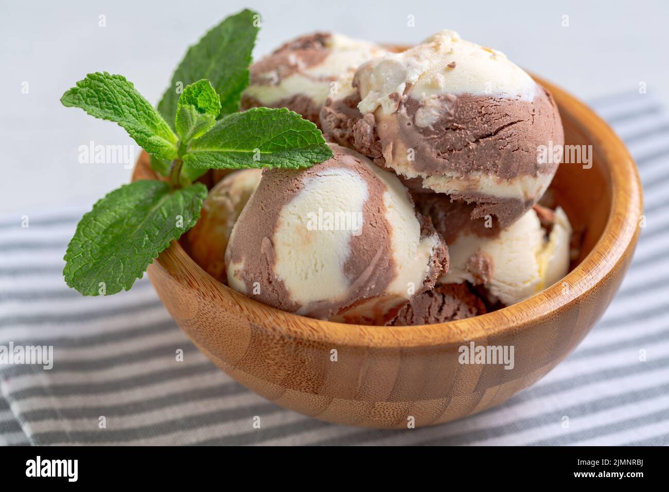 Chocolate-vanilla ice cream in a wooden bowl Stock Photo - Alamy