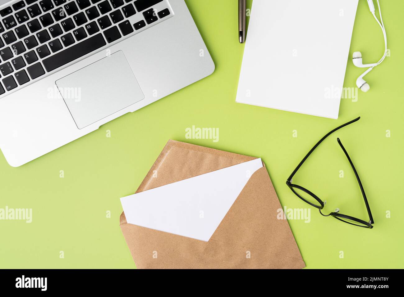 Concept of receiving letter in craft paper envelope at modern workspace, from above Stock Photo