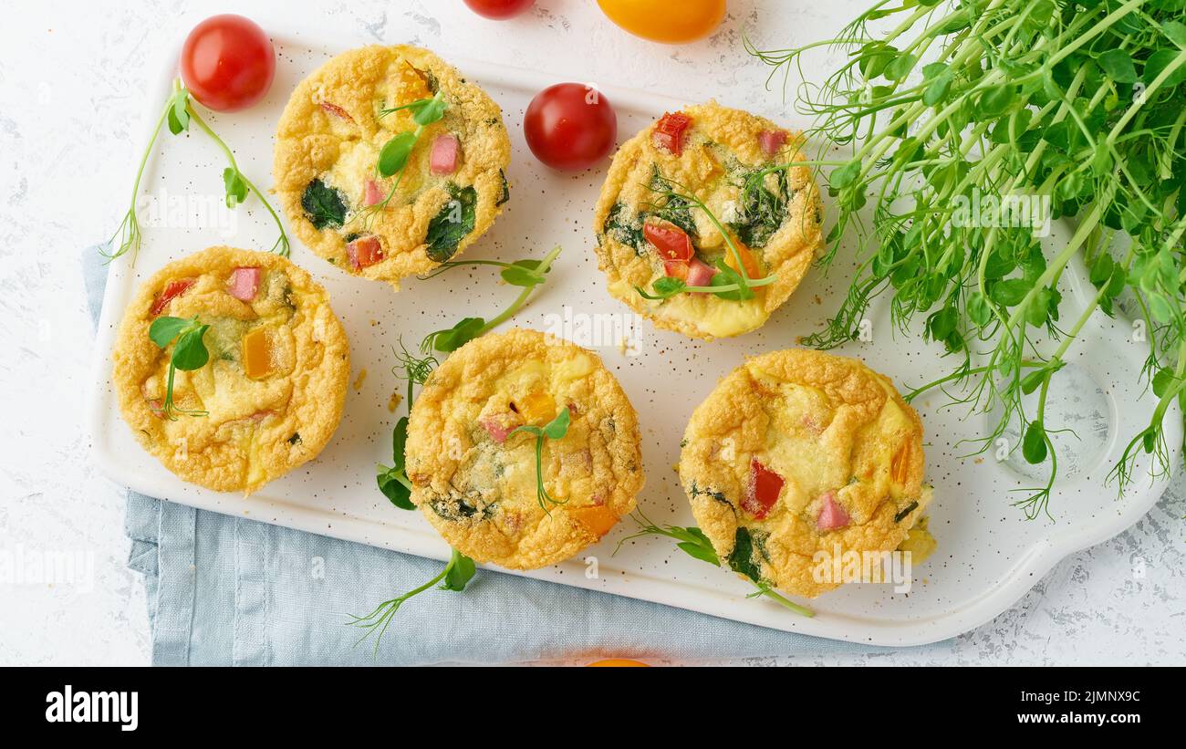 Omelet with tomatoes and bacon, baked eggs with spinach and broccoli, top view, Stock Photo
