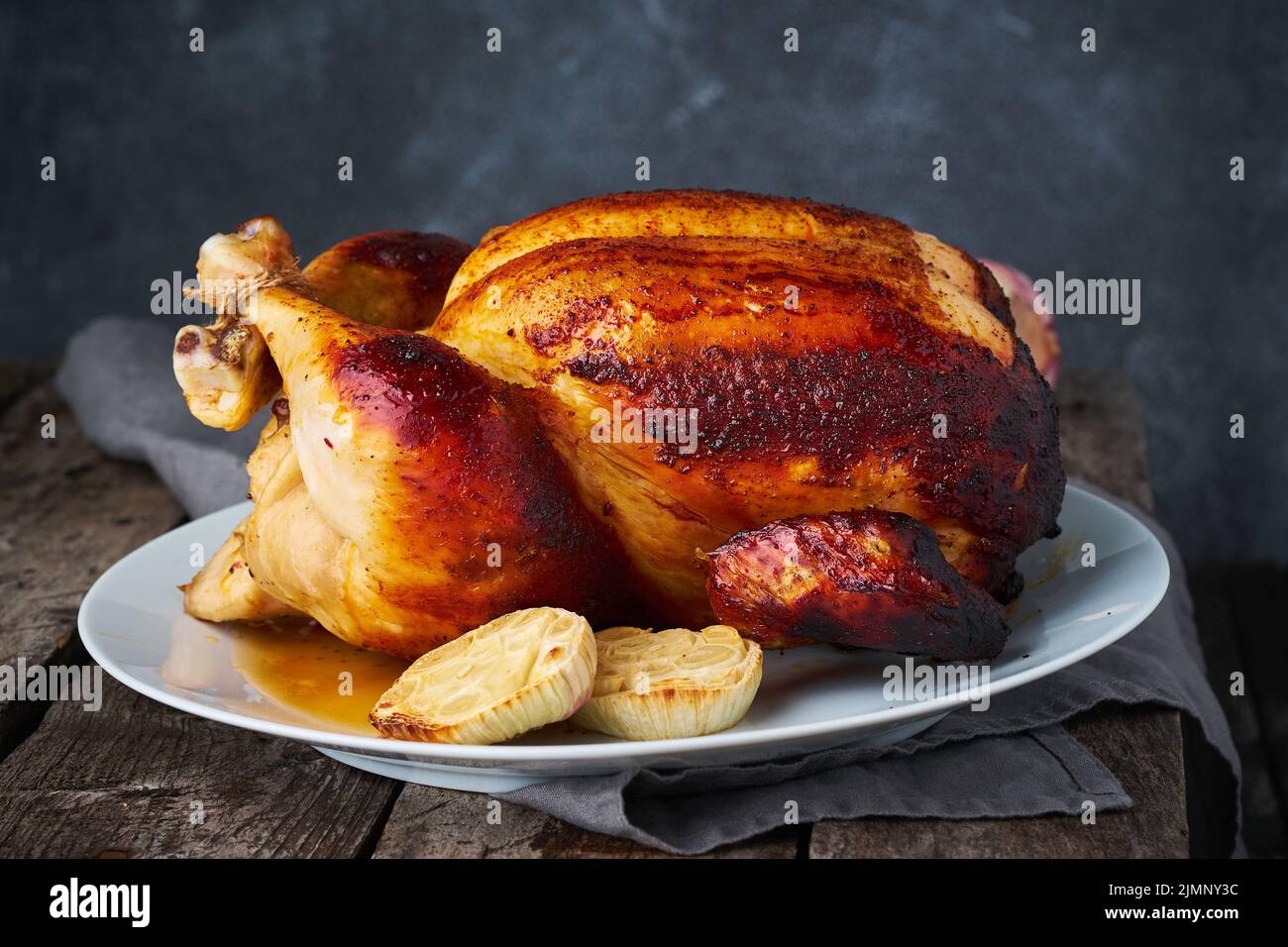 Grilled chicken in blue casserole on dark gray old wooden table, Stock Photo