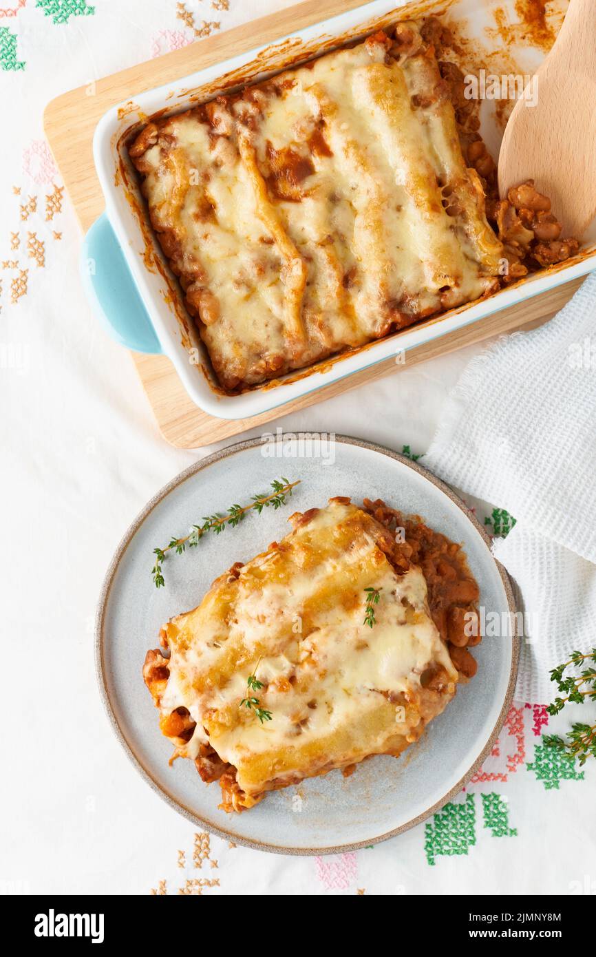 Cannelloni pasta with filling of ground beef, tomatoes, baked with bechamel Stock Photo