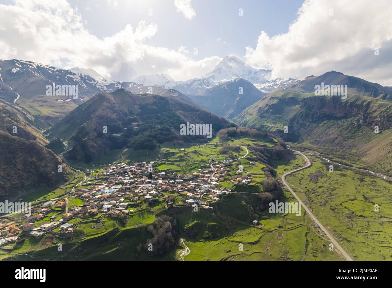 high angle view of Stepantsminda surrounded by the great Caucasus mountains in the sunny weather, Georgia. High quality photo Stock Photo