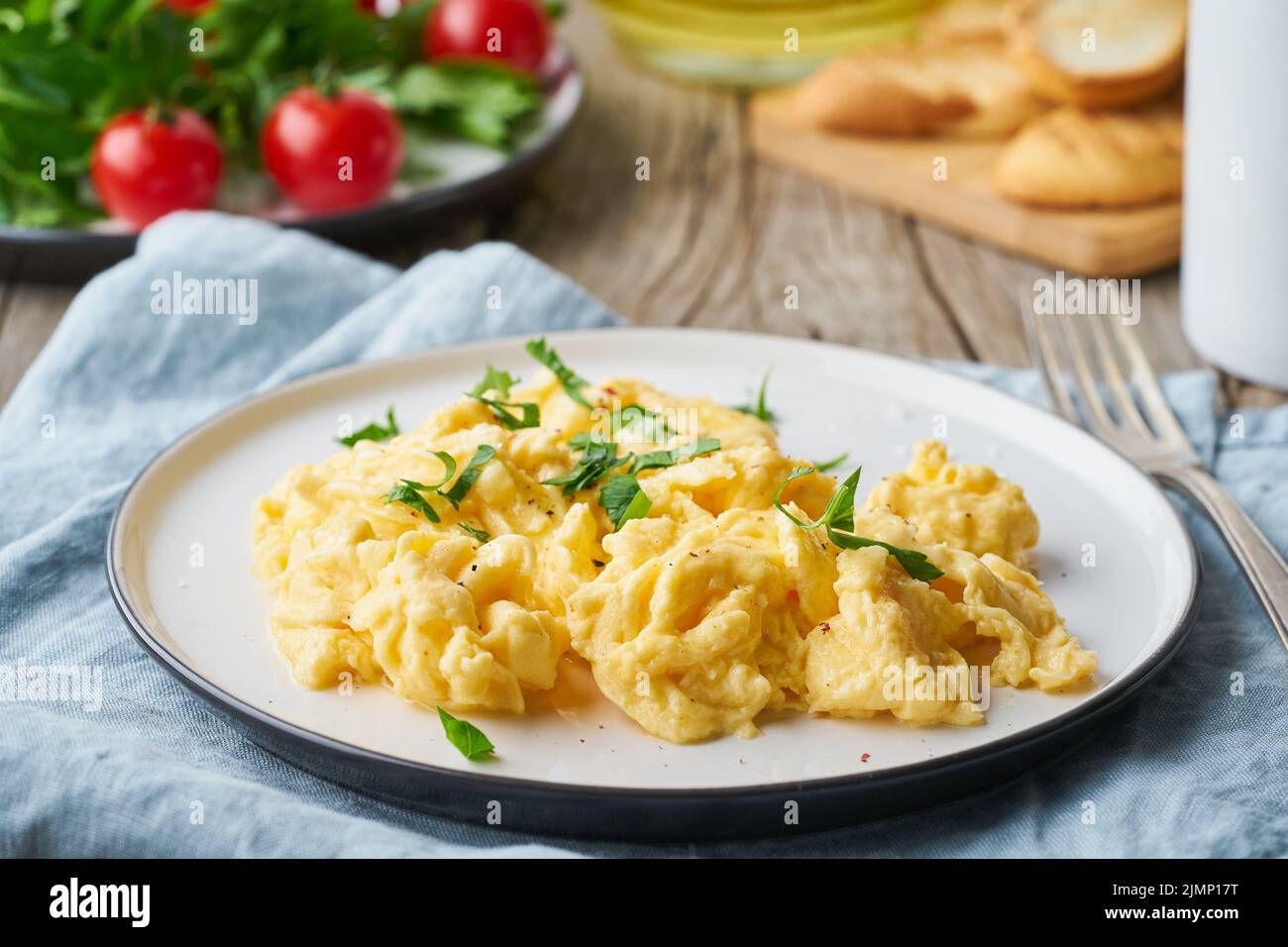 Scrambled eggs, omelette, side view. Breakfast with pan-fried eggs Stock Photo