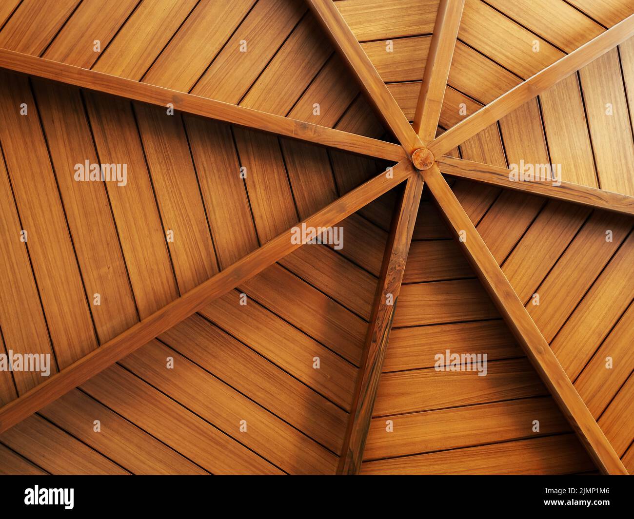 Wooden construction background, arranged to round shape, under the roof. Interior structure of a domed wood plank ceiling, circle pattern, spider web Stock Photo