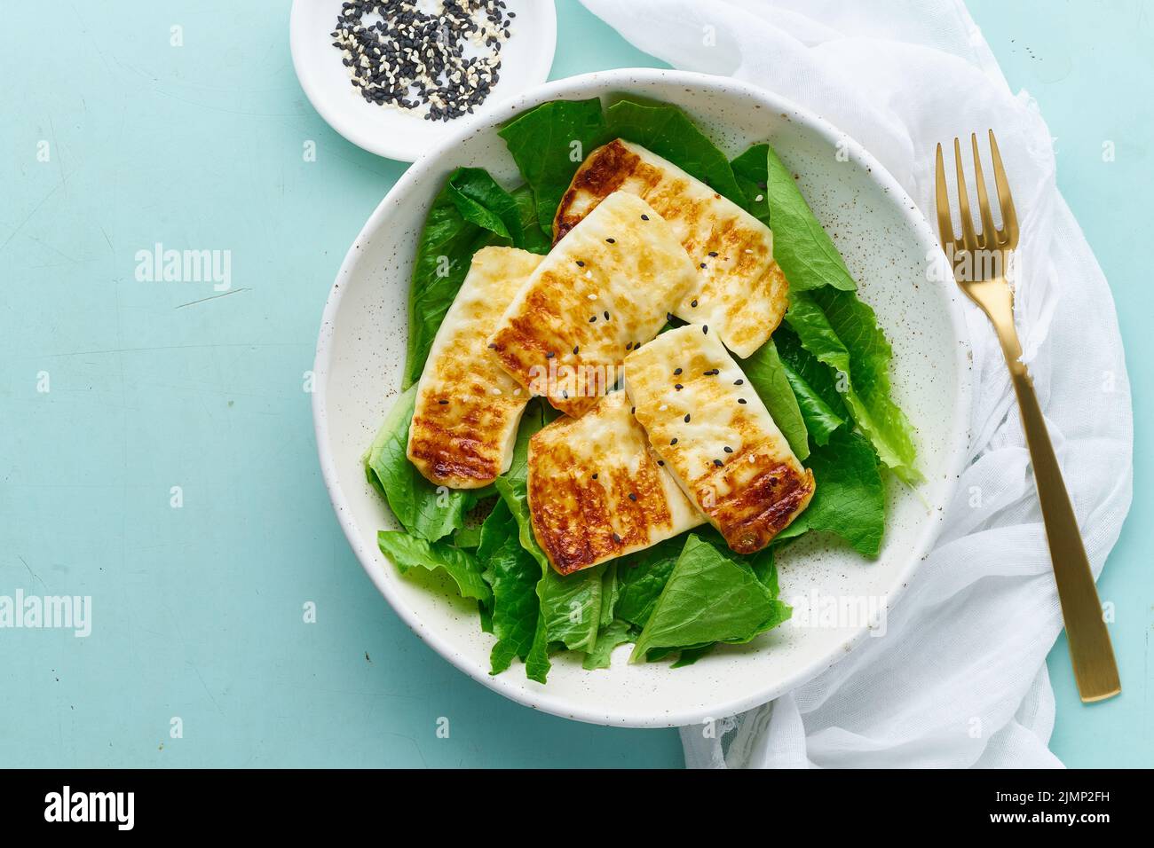 Keto ketogenic diet haloumi with lettuce on pastel background closeup copy space top view Stock Photo
