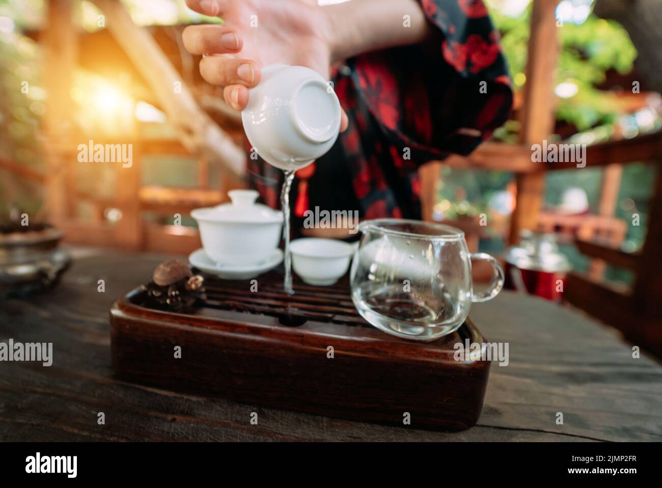 Young girl pouring water from cup closeup Stock Photo Alamy