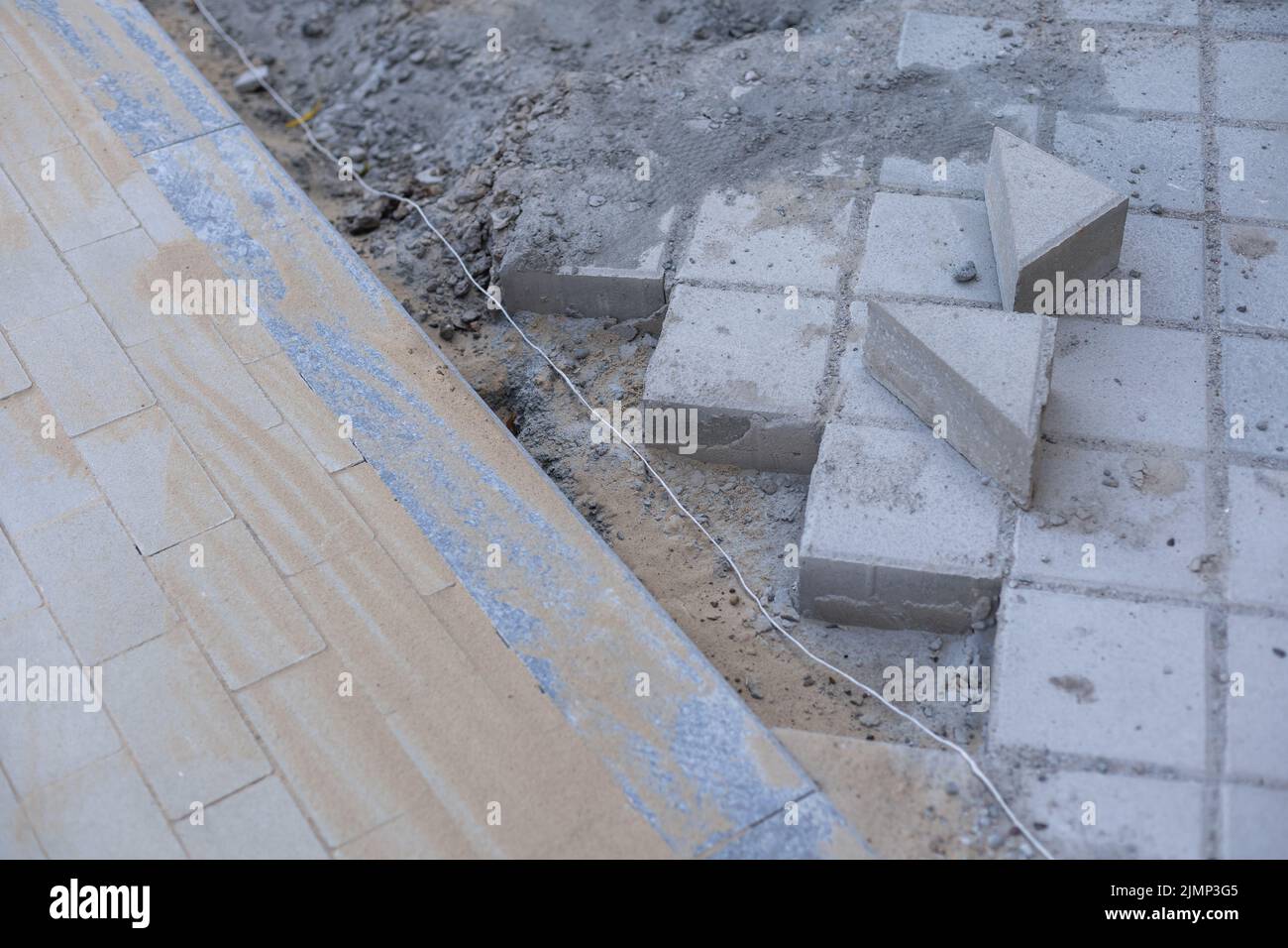 Pavement repair and laying of paving slabs on the walkway, stacked tile ...