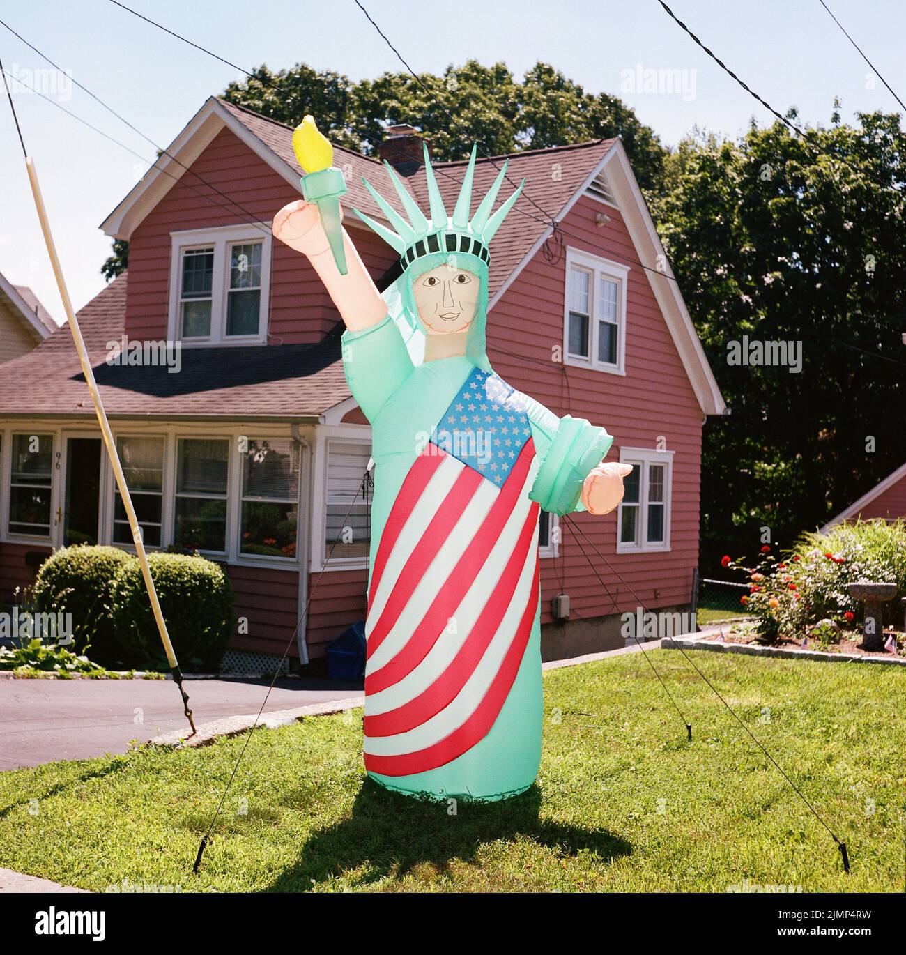 Inflatable Statue of Liberty On Suburban Lawn Stock Photo