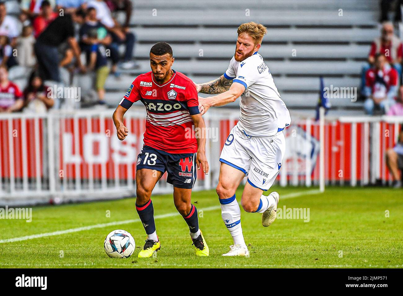 LILLE, FRANCE - AUGUST 7: Akim Zedadka of Lille, Gaetan Charbonnier of Auxerre during the French Ligue 1 match between Lille and Auxerre at Stade Pierre Mauroy on August 7, 2022 in Lille, France (Photo by Matthieu Mirville/Orange Pictures) Stock Photo