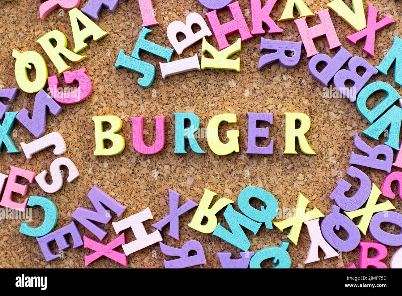 Color alphabet in word burger with another letter as frame on cork