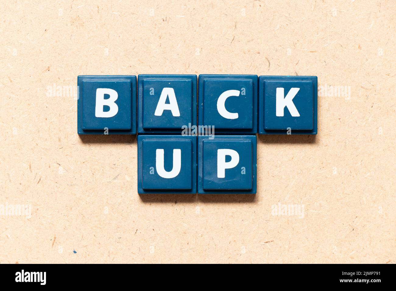 Tile letter in english word back up on wood background Stock Photo