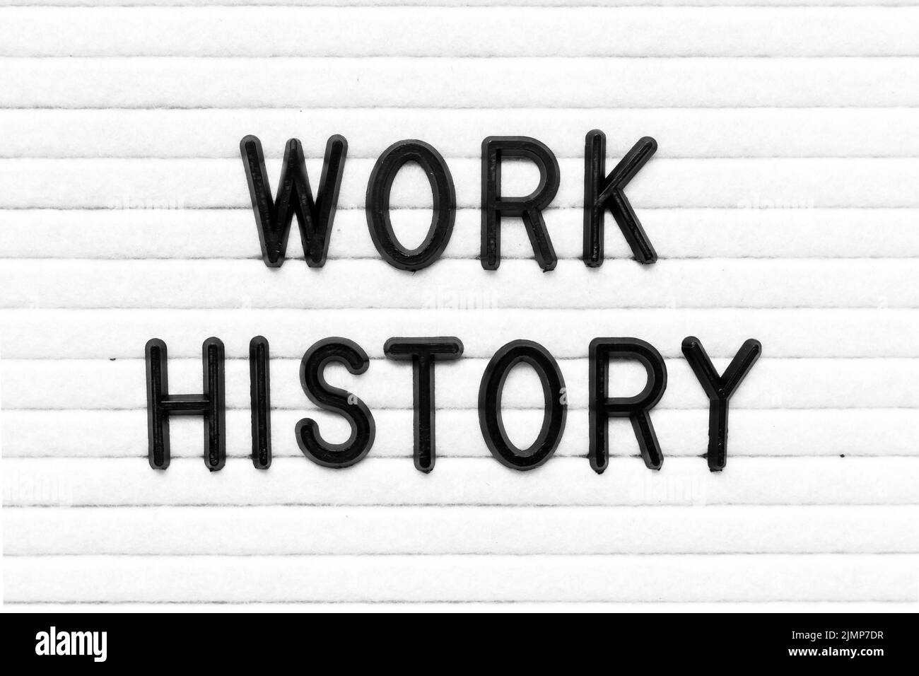 Black color letter in word work history on white felt board background