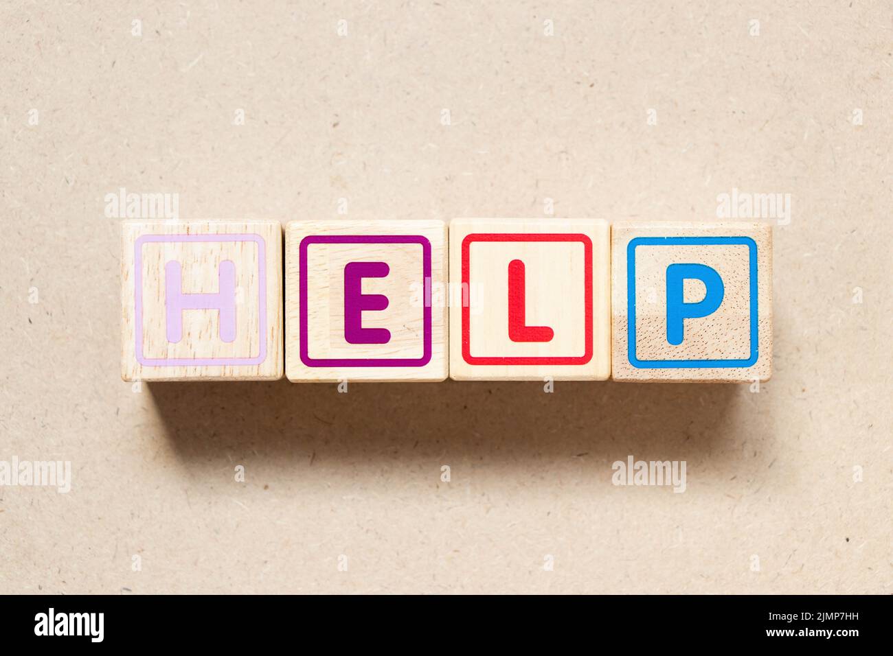 Color letter block in word help on wood background Stock Photo - Alamy