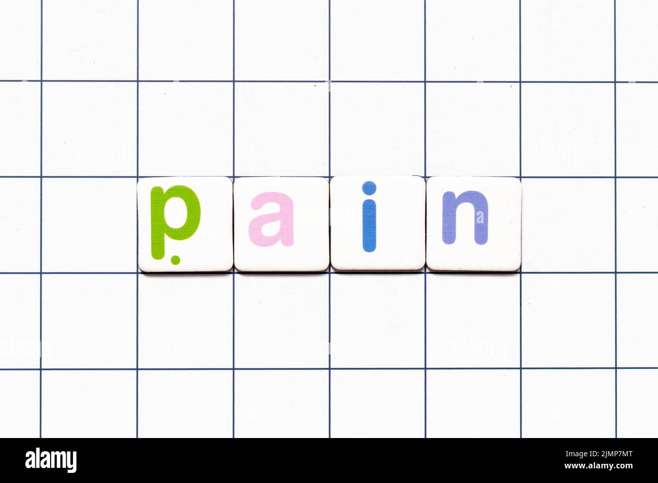 Colorful tile letter in word pain on white grid background Stock Photo