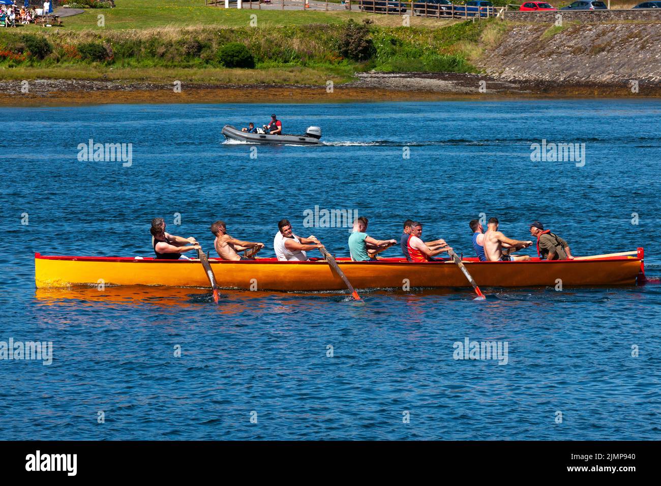 Men and women rowing Seine boat in Portmagee Regatta, County Kerry, Ireland Stock Photo
